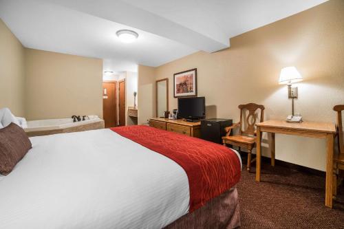 a hotel room with a bed and a desk at K Bar S Lodge, an Ascend Collection Hotel in Keystone