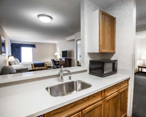a kitchen with a sink and a room with a bed at Comfort Inn Bellingham in Bellingham