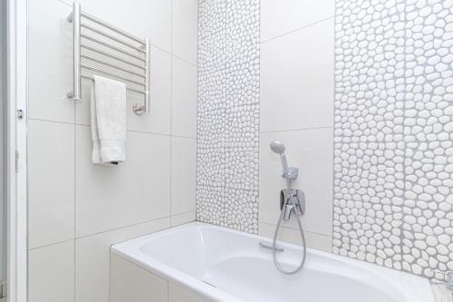 a white bathroom with a shower and a sink at Modern Seaview Apartment in Summerstrand