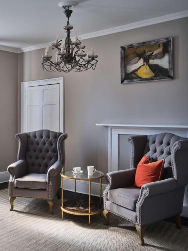a living room with two chairs and a table at Henrietta House, a member of Radisson Individuals in Bath
