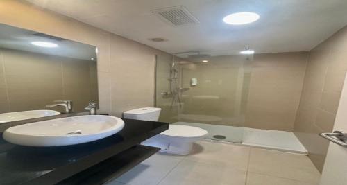 a bathroom with a sink and a toilet and a shower at Fuerteventura Atlantic Gardens Corralejo in Corralejo
