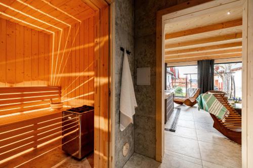 a bathroom with a sauna with wooden walls at Apartament nad Potokiem Sauna, Jacuzzi, SPA in Witów