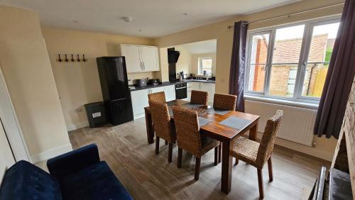a kitchen and dining room with a table and chairs at 15 Main Street in Empingham