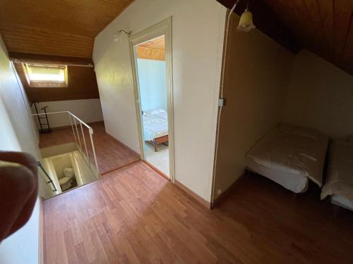a small room with a mirror and a bedroom at Maison campagne Morvan Anost in Anost