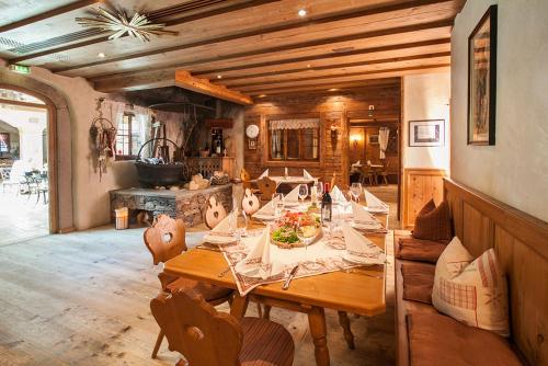a dining room with a wooden table and chairs at Alpenrast Tyrol in Mils bei Imst