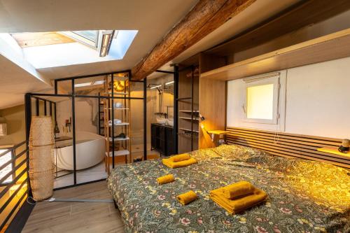 a bedroom with a large bed and a bath tub at Loft COSY et luxueux, HYPER-CENTRE in Aix-en-Provence