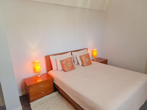 a bedroom with a bed and two lamps on night stands at Basilio's Villa in Funchal