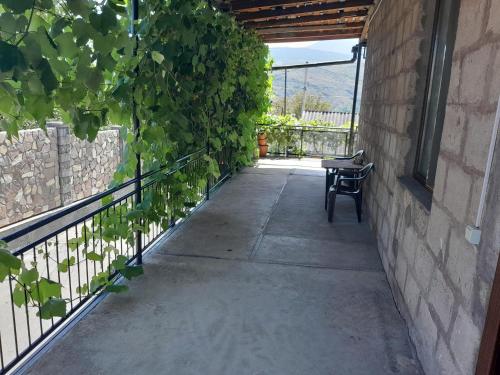a walkway with a bench next to a wall at Akhaltsikhe hotel “Sunny House” in Akhaltsikhe