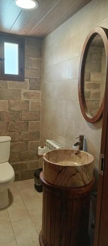 a bathroom with a wooden sink and a mirror at Rokwood faraya in Ash Sha‘rah
