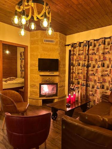 a living room with a couch and a fireplace at Rokwood faraya in Ash Sha‘rah