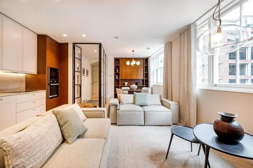 a living room with a couch and a table at Covent Garden 2 bed 2 bath duplex in London