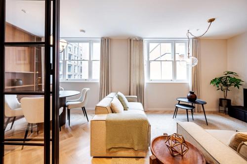 a living room with a couch and a table at Covent Garden 2 bed 2 bath duplex in London