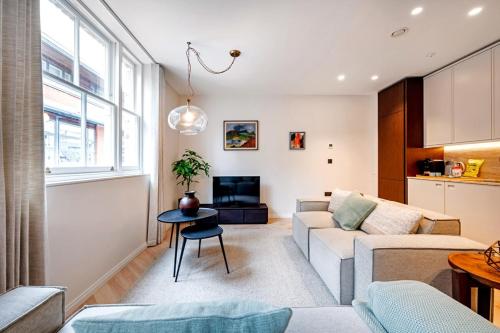 a living room with a couch and a table at Covent Garden 2 bed 2 bath duplex in London