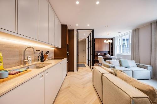 a kitchen and living room with a couch and a table at Covent Garden 2 bed 2 bath duplex in London