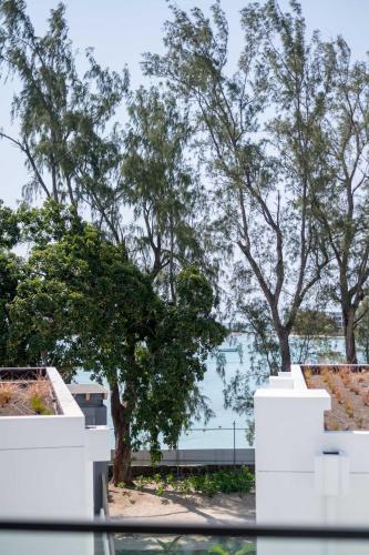 a view from a window of trees and a building at Casa Alegria Beach Apartment in Pereybere