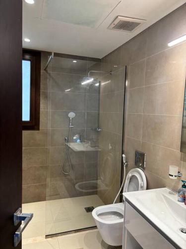 a bathroom with a shower and a toilet and a sink at Hawana Salalah Resort - Acacia 51 in Ma‘mūrah