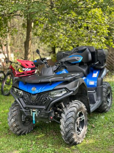 a blue atv parked in the grass at Shoda Valley შოდა ველი in Oni