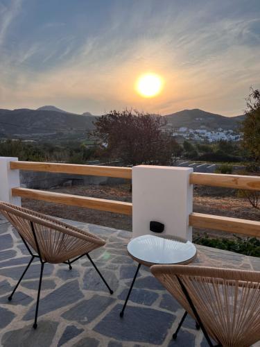 a patio with a table and chairs at sunset at Serenity Apartment in Engares