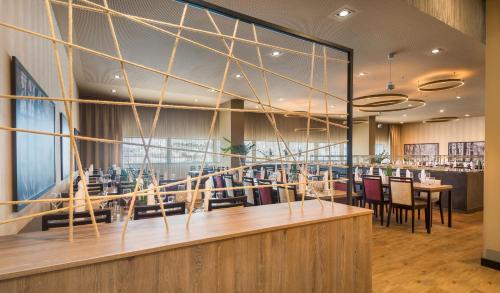 a dining room with a table and chairs at Wyndham Grand Salzburg Conference Centre in Salzburg