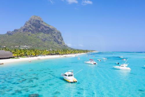a group of boats in the water near a beach at Villa Ayapana in Le Morne
