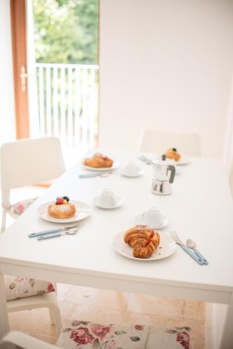 a white table with plates of pastries on it at I Trulli e la Luna in Alberobello