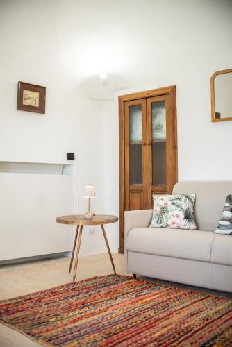 a living room with a couch and a table at I Trulli e la Luna in Alberobello