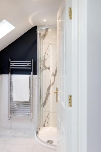 a shower with a glass door in a bathroom at Pack Horse Inn - New Mills in Mellor