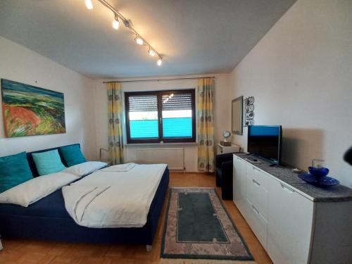 sypialnia z łóżkiem i biurkiem z telewizorem w obiekcie Appartment Cerny w mieście Eisenstadt