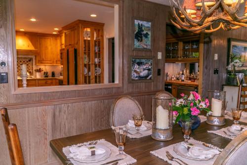 a dining room with a table with plates and flowers at Hinesight at Hound Ears in Valle Crucis