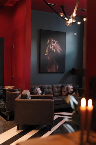a living room with a couch and a painting on the wall at The Saafe luxury apartments in Berwick-Upon-Tweed