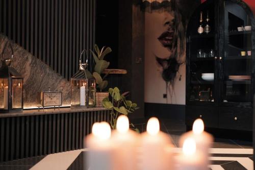 a room with a table with lit candles on it at The Saafe luxury apartments in Berwick-Upon-Tweed