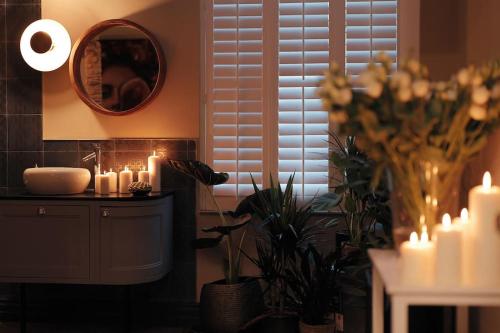 a room with candles and plants and a mirror at The Saafe luxury apartments in Berwick-Upon-Tweed
