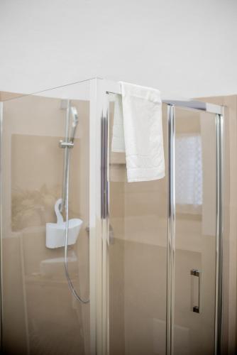a bathroom with a shower with a glass door at I Trulli e la Luna in Alberobello