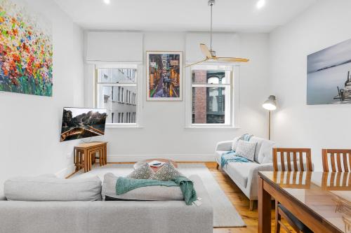 a living room with a couch and a table at Flinders Lane Apartments in Melbourne