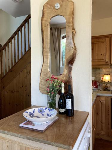a table with two bottles of wine and a mirror at No 10 Coastguard Station in Renvyle
