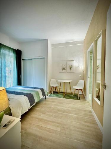 a bedroom with a bed and a table and chairs at Home 120, Mansion Alhamar in Sitio de Calahonda