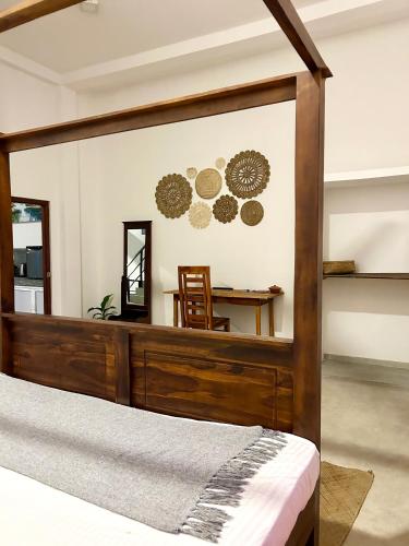a bedroom with a bed and a mirror at One Bhakthi in Ahangama