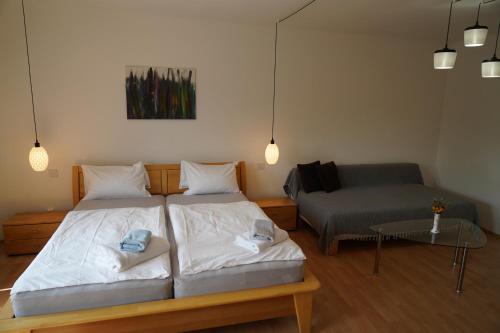 a bedroom with two beds and a couch at Landhaus Krell in Mitterretzbach