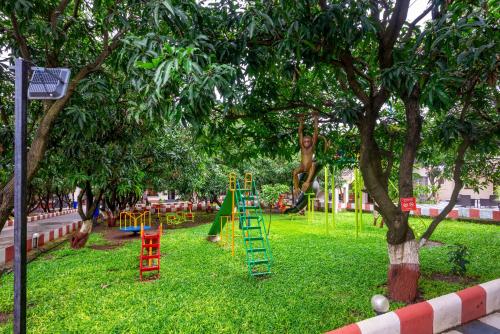 a playground with colorful play equipment in a park at Freesia Resort by Express Inn in Nashik