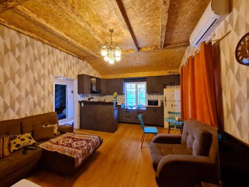 a living room with a couch and a table at Pine house in Gürgan