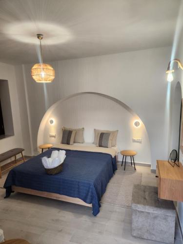 a bedroom with a large bed with a blue blanket at Traditional Apartments Alexandra in Meyisti
