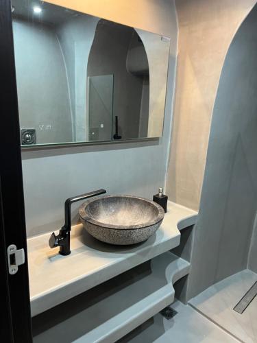 a sink in a bathroom with a mirror at Dome in Kharoúdha