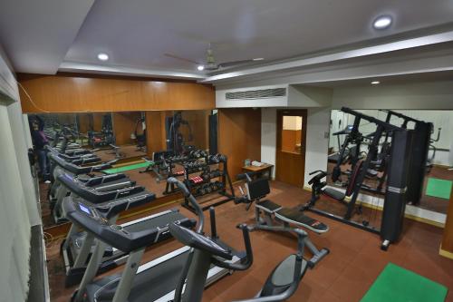 a gym with a row of treadmills and machines at Comfort Inn in Lucknow