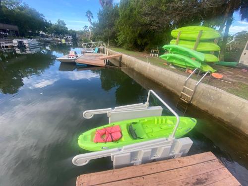 two boats are docked on a dock in the water at Neptune's Grotto Old Florida Adventure Retreat in Spring Hill