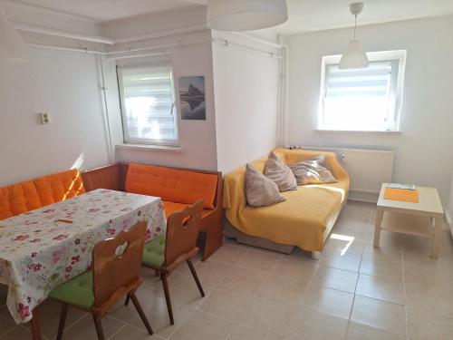 a living room with a couch and a table at Ferienwohnung Anja in Sonneberg