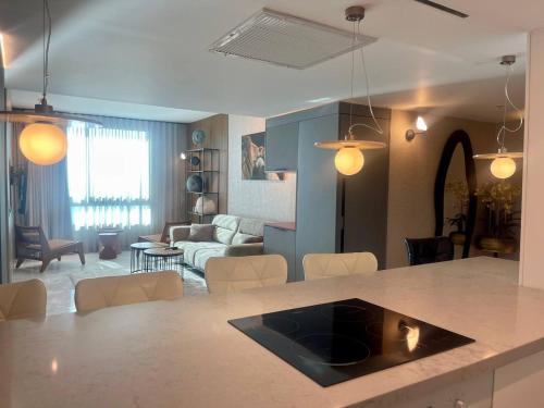 a kitchen and living room with a table and a living room at C Tower Premium Apartments, Panoramic Sea View in Netanya
