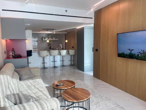 a living room with a couch and a table at C Tower Premium Apartments, Panoramic Sea View in Netanya