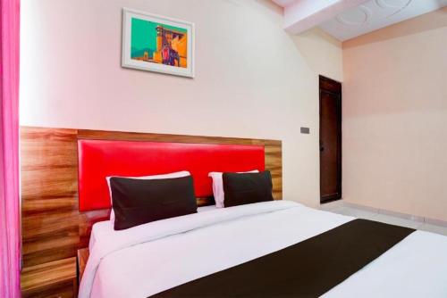 a bedroom with a large bed with a red headboard at Hotel STAY INN in Haldwāni