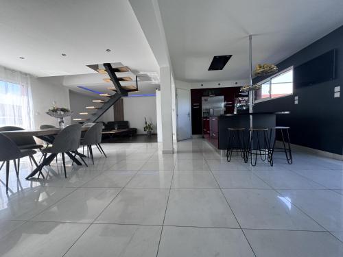 un salon et une salle à manger avec une table et des chaises dans l'établissement Le QG des Bolides - 15 pers - Circuit - Rêve au Mans, à Saint-Mars-dʼOutillé