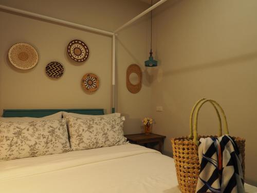 a bedroom with a bed and some plates on the wall at Seamoon House in Tainan